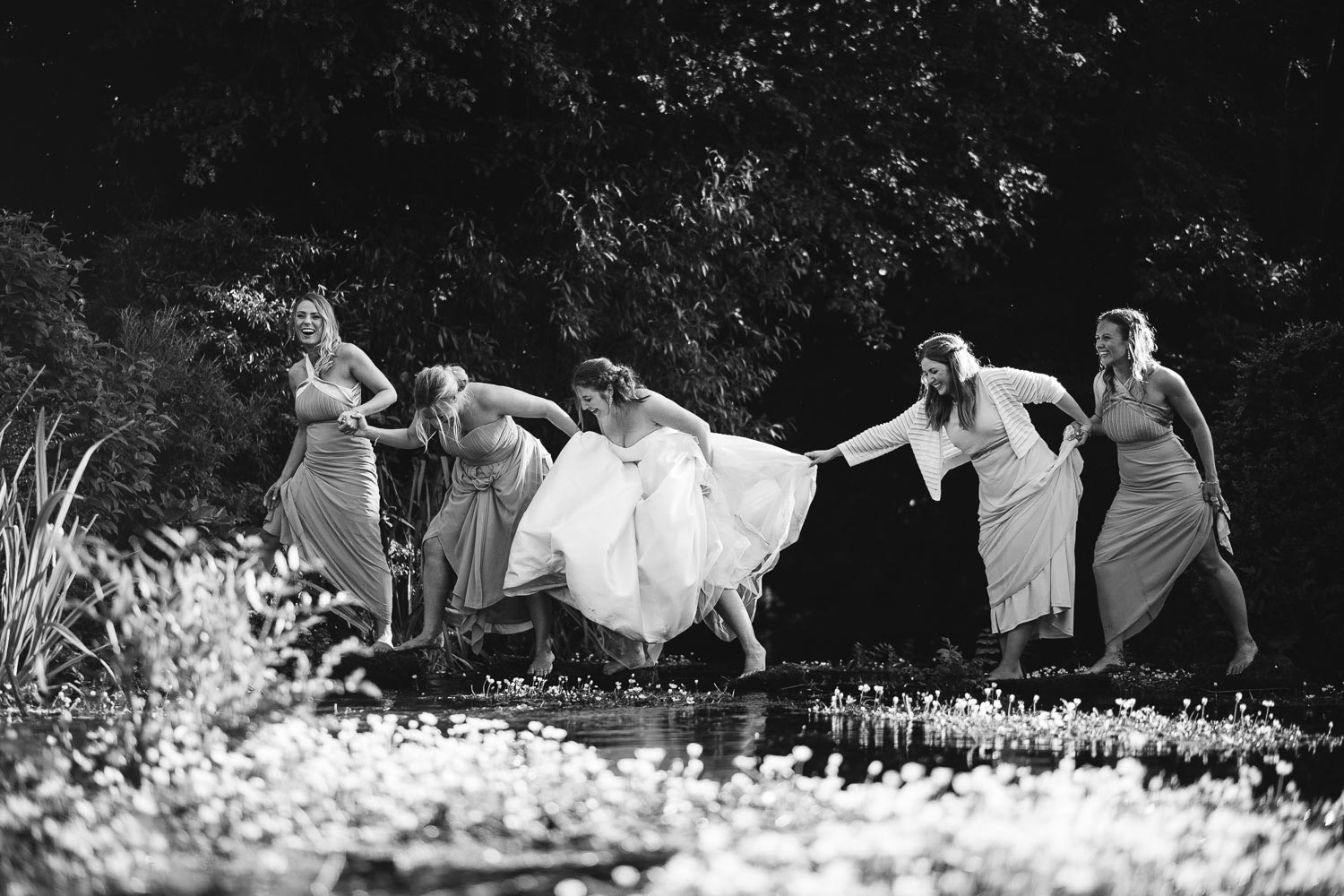 Bridesmaids cross a river